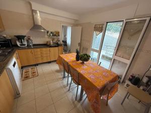 a kitchen with a table with a table cloth on it at Casa do sol in Santa Cruz