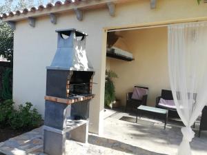 a outdoor pizza oven in the backyard of a house at Sweet House in Islas Baleares