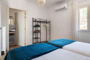 a bedroom with a large bed with a blue blanket at Sweet House in Islas Baleares +74 photos