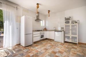 a kitchen with white appliances and a tile floor at Sweet House in Islas Baleares