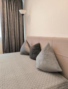 a bed with two pillows on top of it at Butas šalia parko in Radviliškis