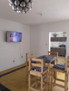 a dining room with a table and two chairs at Habitación exclusiva para hombres LGBT in Mazatlán +3 photos