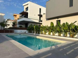 a swimming pool in front of a house at Diamond A2 in Iraklitsa