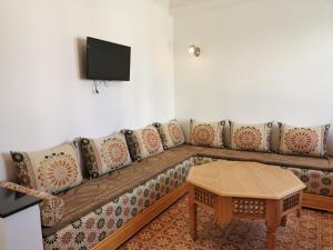 a living room with a couch and a table at Maison d'Hôtes Casa Azla in Azla