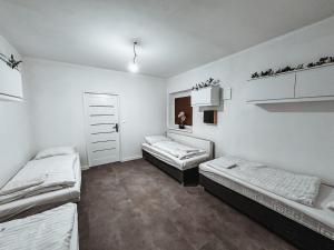 a room with three beds and a window at Cozy B&B Home in Banská Bystrica