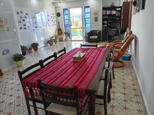 a dining room with a red table and chairs at Maison d'Hôtes Casa Azla in Azla