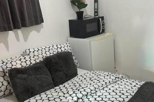 a bedroom with a bed and a tv on a cabinet at Studio flat with private entrance in Lewisham