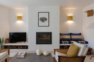a living room with a couch and a fireplace at Casa Mondina Townhouse in Alcácer do Sal