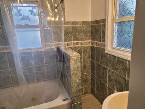 a bathroom with a shower and a toilet and a sink at Two-Bedroom Home 25 min to NYC Free parking-UNIT-1 in Teaneck +16 photos
