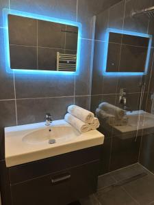 a bathroom with a sink and a mirror at SG Apartment in Essen