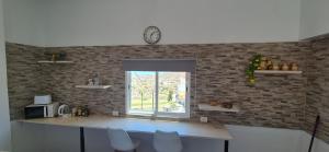 a kitchen with a counter and a clock on the wall at Studio in Arico Teguedite in La Sabinita