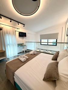 a large bed with two towels on top of it at Diamond A3 in Iraklitsa +16 photos