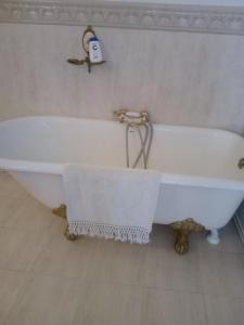 a white bath tub in a bathroom with a shower at Casa de Comedias in Almagro +42 photos