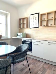 a kitchen with a table and chairs and a stove at Anne in Sankt Pölten
