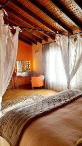 a bedroom with a large bed and a window at La Solana in Ancillo