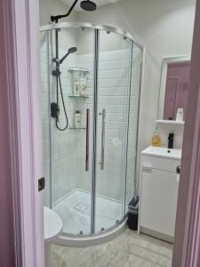 a glass shower in a bathroom with a sink at Private Room near Airport in Mississauga +39 photos