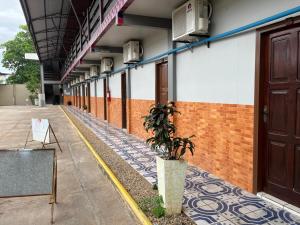 an empty corridor of a building with a potted plant at Hotel Panachê in Boa Vista