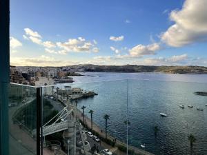 a view of a body of water with boats in it at Stunning Sea View Apartment in St Paul's Bay