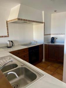 a kitchen with a sink and a counter top at Apartamento La casa Verde in Punta Prima +37 photos