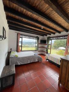 Postel nebo postele na pokoji v ubytování Hotel Campestre Casa Jaz