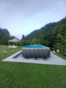a swimming pool in the middle of a grass field at Holiday home "Aida" in Visoko