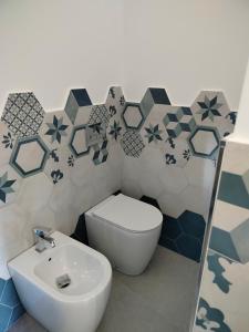 a bathroom with a toilet and a sink at Maruzzé luxury room in Albori +27 photos