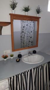 a bathroom counter with a sink and a mirror at Apartamento OGUM Cáceres in Cáceres +19 photos