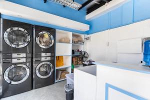 a kitchen with four washing machines in a room at Diamond Hall Cebu - 201 in Cebu City