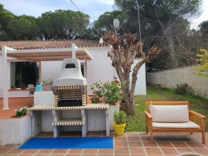 a backyard with a large bell in the yard at Villa Serena - Casa rural en Arcos con piscina, barbacoa, chimenea in Arcos de la Frontera