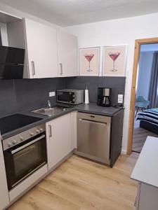 a kitchen with a sink and a stove top oven at Ferienwohnung mit Burgblick in Mayen +50 photos