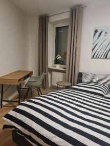 a bedroom with a bed and a desk and a window at Ferienwohnung mit Burgblick in Mayen