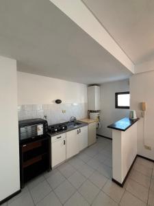 a kitchen with a sink and a stove top oven at Departamento en el centro de Rafaela in Rafaela
