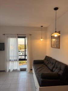 a living room with a couch and a window at Departamento en el centro de Rafaela in Rafaela