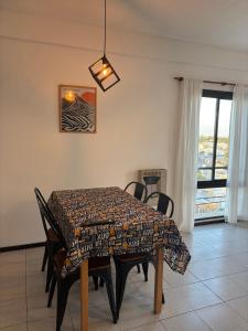 a dining room with a table and chairs and a window at Departamento en el centro de Rafaela in Rafaela +2 photos