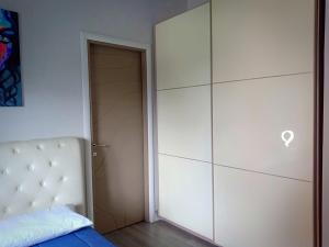 a bedroom with a bed and a large closet at Le Stanze di Marco in Monza