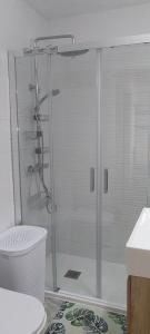 a shower with a glass door in a bathroom at Casa Dolores in Puerto de Mazarrón +26 photos