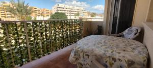 a balcony with a bed and a view of a city at Casa Dolores in Puerto de Mazarrón