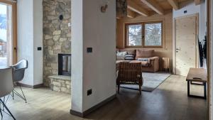 a living room with a couch and a fireplace at Nix & Nivis Chalet in Livigno