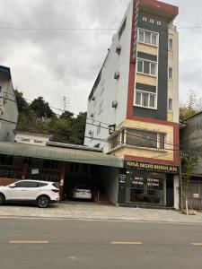a white car parked in front of a building at Minh An in Dien Bien Phu