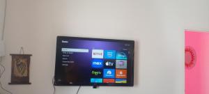 a flat screen tv sitting on a wall at Tierra de Mariposas in Alta Gracia +14 photos