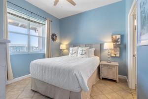 a blue bedroom with a bed and a window at Gulf Place Cabanas in Santa Rosa Beach +46 photos