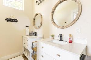 a bathroom with a sink and a mirror at Riverscape Townhome B, Steps to Gruene Hall! in New Braunfels +15 photos
