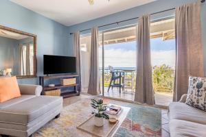 a living room with a couch and a large window at Gulf Place Cabanas in Santa Rosa Beach