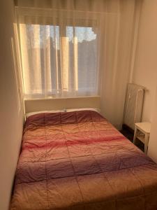 a bed in a small room with a window at Anna Apartment in Padova +15 photos