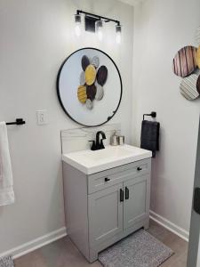 a bathroom with a sink and a mirror on the wall at Private 2 bedroom duplex in Stafford +17 photos