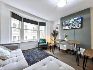 a living room with a couch and a table at The Seaside Snug in Brighton & Hove