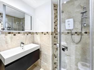 a bathroom with a sink and a shower at The Seaside Snug in Brighton & Hove