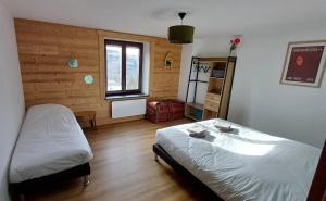 a bedroom with two beds and a window at Chez Bernadette in La Bresse