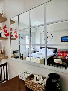 a bedroom with a mirror and a bed in it at Our Happy Place - Cheer Residences in Marilao +11 photos