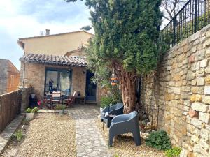 a patio with chairs and a tree next to a building at La Maisonnette de Bédoin Mont Ventoux - Self Check In in Bédoin +24 photos